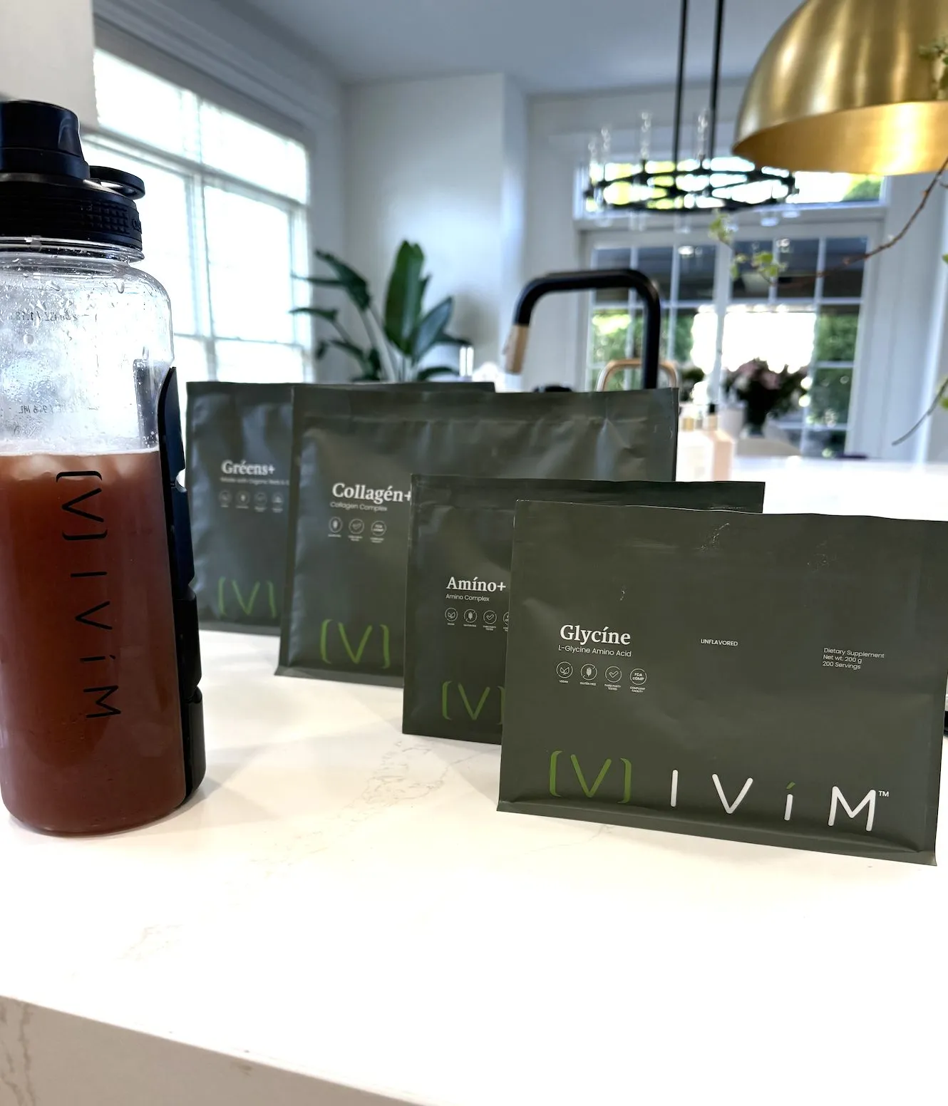 Ivím supplement pouches and water bottle on the kitchen island